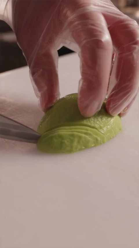 Slicing ripe avocado into paper thin pieces using japanese knife Stock Footage 337119203