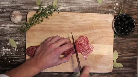 Slicing salami for pizza Stock Footage 58418346