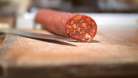 Slicing sausage. sharp salami. Stock Footage 121085952