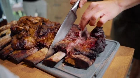 Slicing Slow Cooked Barbecue Beef Ribs on Cutting Board Stock Footage 328382330