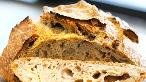 Slicing sour dough artisan bread Stock Footage 101215236