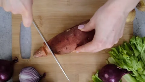 Slicing sweet potato Stock Footage