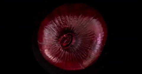 Slicing through a red onion in stop motion animation. Filmed on black Stock Footage 75736088
