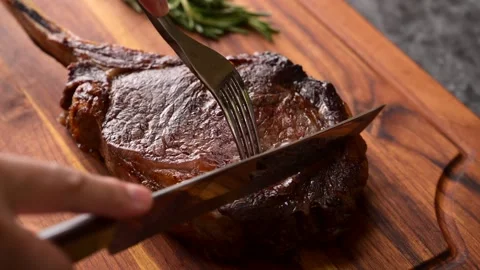Slicing tomahawk steak with knife Stock Footage 269560829