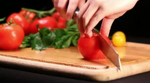 Slicing tomato on cutting board Stock Footage 22195231