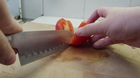 Slicing tomato on a cutting board Video stock 286843153