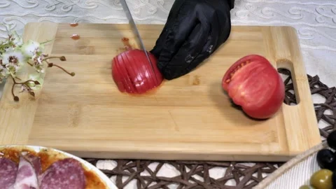 Slicing a Tomato into Half-Moons with a Kitchen Knife Stock Footage 311268950