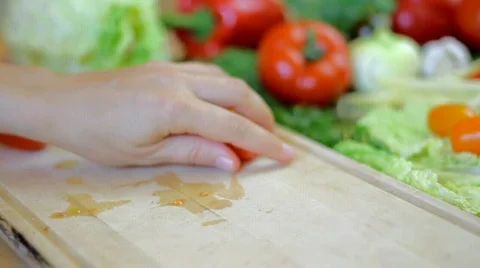 Slicing tomato, pan shot and slow motion Stock Footage