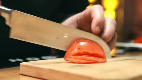 Slicing of a tomato in the restaurant kitchen Stock Footage 153162299