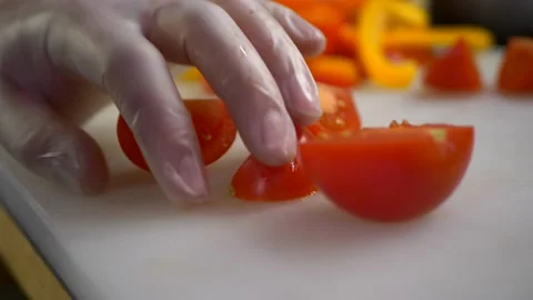 Slicing tomatoes with large kitchen knife Stock-Footage 193765739