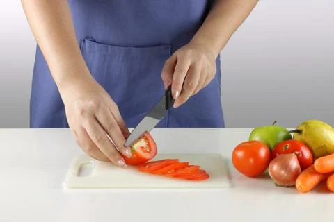 Slicing tomatoes Stock Photos