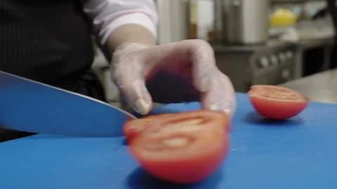 Slicing tomatoes in a restaurant while preparing a Greek salad. Stock Footage 114889259