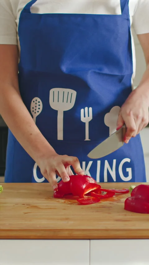 Slicing vibrant bell peppers by hand in a bright kitchen setting Stock Footage 341762476