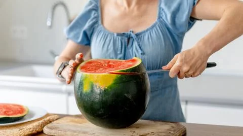 Slicing Watermelon In The Kitchen Stock Photos
