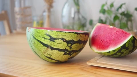 Slicing a watermelon on a wooden table Stock Footage 340597202