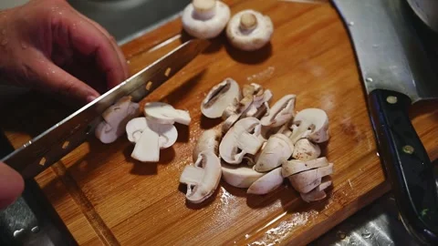 Slicing White Button Mushrooms into Pieces for Cooking Stock Footage 346487669