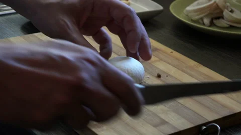 Slicing a white mushroom 4K Stock Footage 130873036