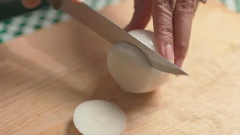 Slicing white onion in the kitchen close up Stock Footage 191571576
