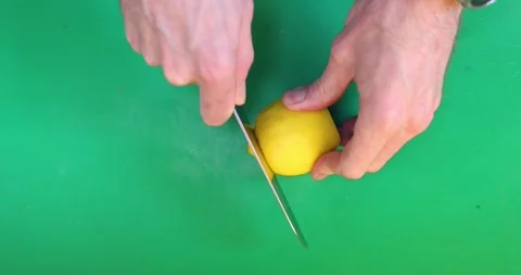 Slicing a whole lemon Stock Footage 289411032