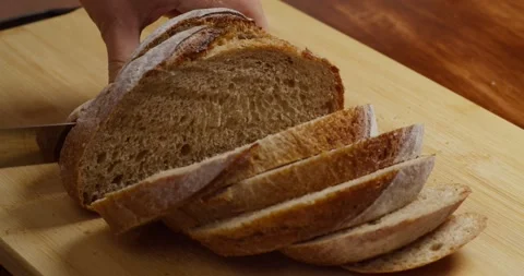 Slicing Wholegrain Bread Cri On Slice For Bruschetta. Cutting Sourdough Bread On Stock Footage 320558934