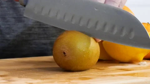 Slicing a Yellow Kiwi Stock Footage 161670796