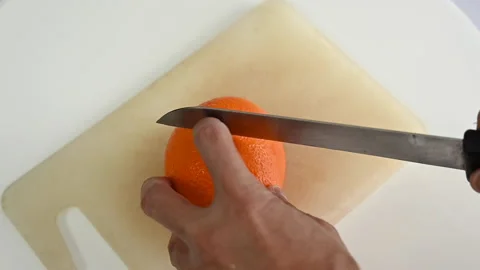Slicing yellow or orange fruit Stock Footage 160959974