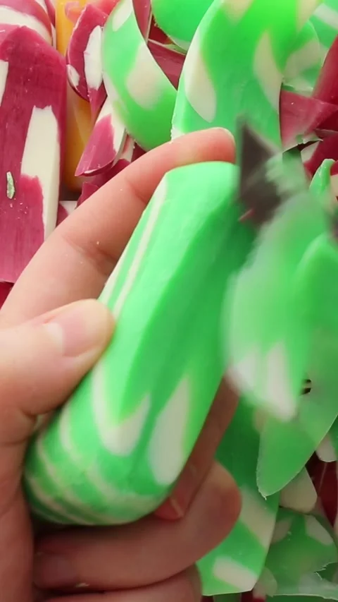 Slicing a yellow soap bar with white stripes in smooth motions. The vibrant Stock Footage 313753366