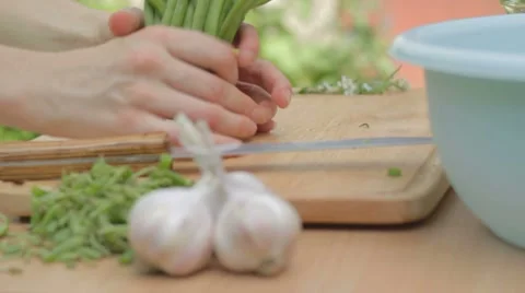 Slicing young green string beans into long pieces on board Stock Footage 8367560