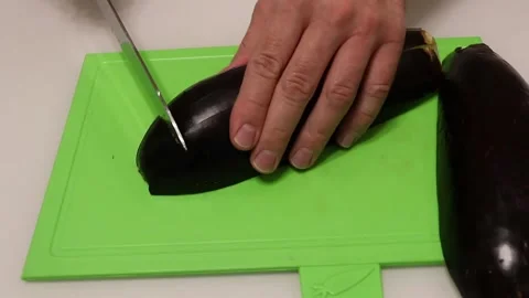 Slicing zucchini on a cutting board Stock Footage 137600587