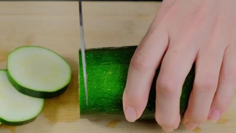Slicing Zucchini with Knife in Cooking Kitchen Stock Footage 341461341