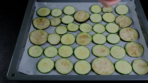 Slicing Zucchini Rounds on Baking Sheet at Cooking Location Stock Footage 341421378