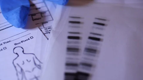 Slide across Forensic paperwork DNA sample Stock Footage 98586401