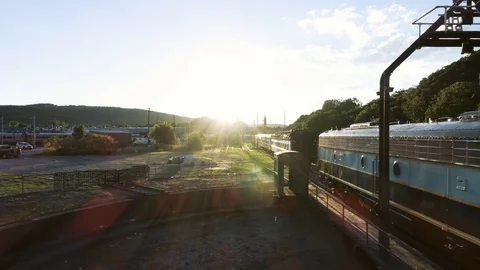 Slide Across front of Train with Sun Popping through Stock Footage 91900972