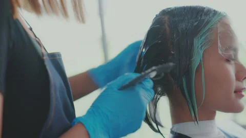 The slide camera moves slowly. Gradually focus on customer. The barber is usi Stock Footage 153825134