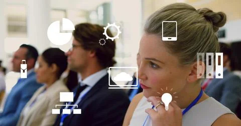 Slide change causing early-career female with blue lanyard studying data icons Stock Photos