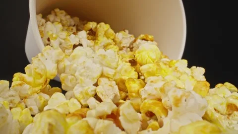 Slide dolly shot of popcorn. Camera moving out of delicious pop corn. Video stock 243453660