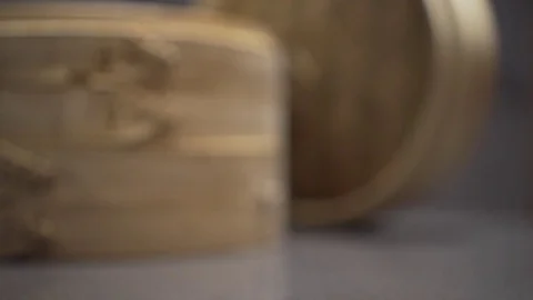 Slide into focus on bamboo dumpling container. slow motion.  Video stock 78886236