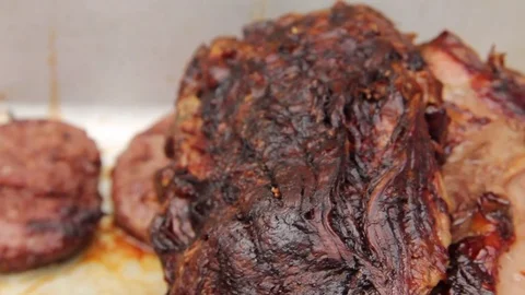 Slide forward over 2 cuts of beef at a BBQ Stock Footage 80437069