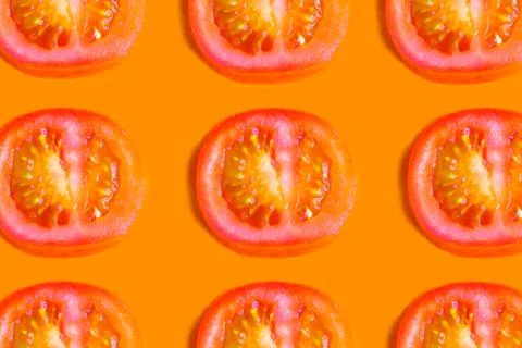 Slide fresh tomato pattern on orange background, minimalism concept Stock Photos