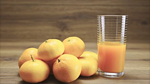 Slide from left with mandarin juice ready to serve 4K Stock Footage 73338337