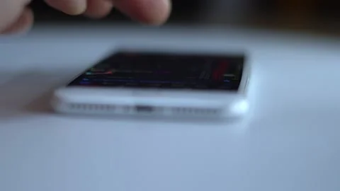 Slide the mobile phone screen to speculate in stocks Stock Footage 150470265