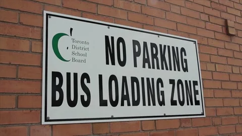 Slide motion left to right of toronto district school board no parking bus load Video stock 246136113