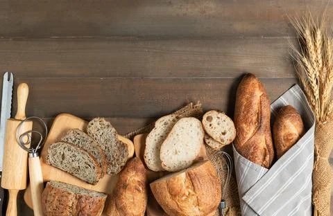 Slide multi grain sourdough bread and sliced Baguette on wood background, 스톡 사진