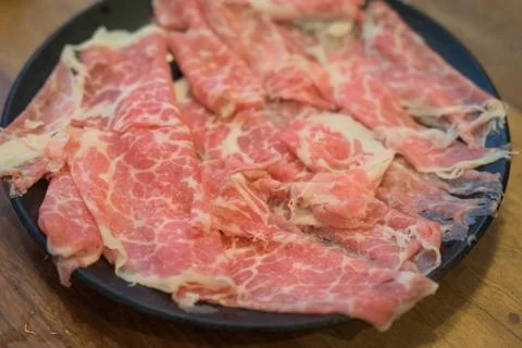 Slide raw beef on a dish Stock Photos