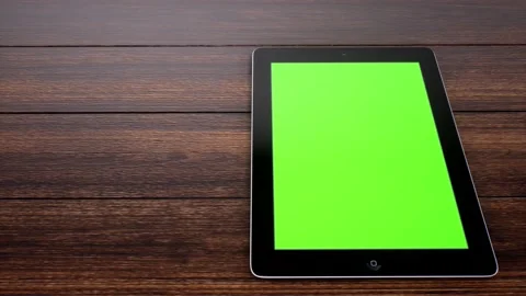 A Slide right of tablet laying on desk displaying green screen Stock Footage 155222682