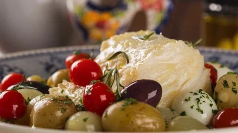 Slide shot codfish on the plate with smoke.  Video stock 107755547