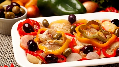 Slide shot Codfish with vegetables and ingredients in the background with smoke. Video stock 107754710