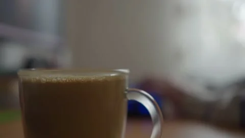 Slide shot of a cup of coffee on a work table and hands typing on the keyboard 動画素材 234121691