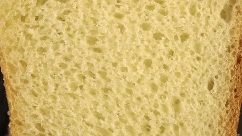 Slide shot of a piece of white bread. Slow Macro Dolly of Wheat Bun. Stock Footage 203824757