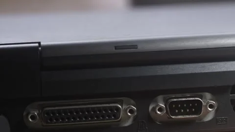 Slide shot reveals I/O peripheral connection ports on old computer laptop Stock Footage 312321041